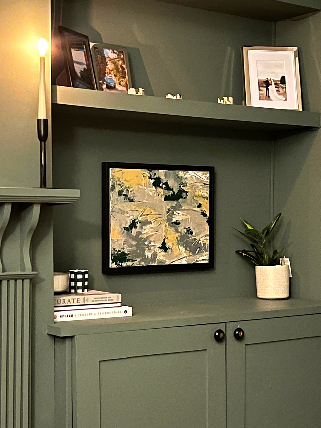 Small abstract on green shelving