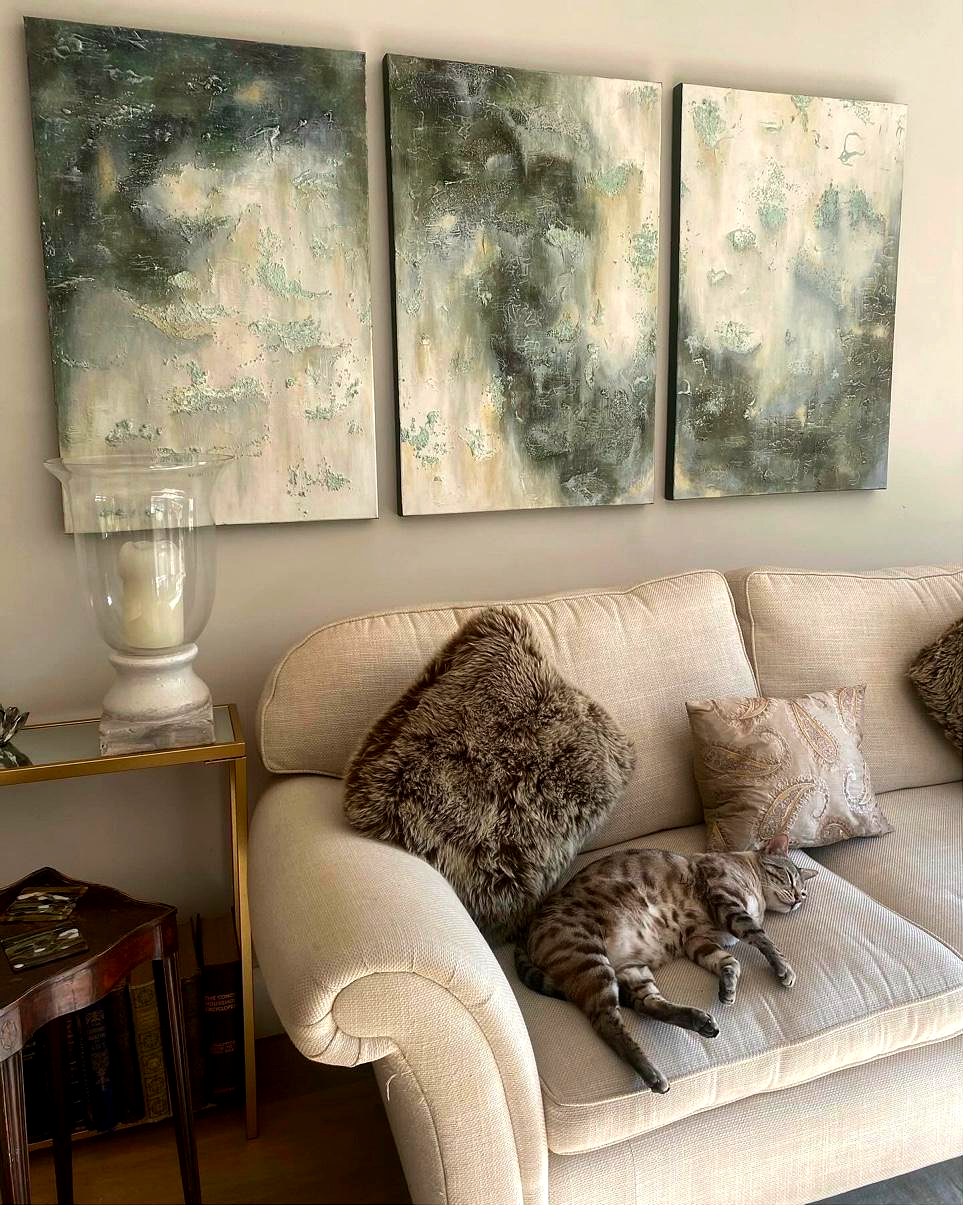 Green triptych in living room with cat